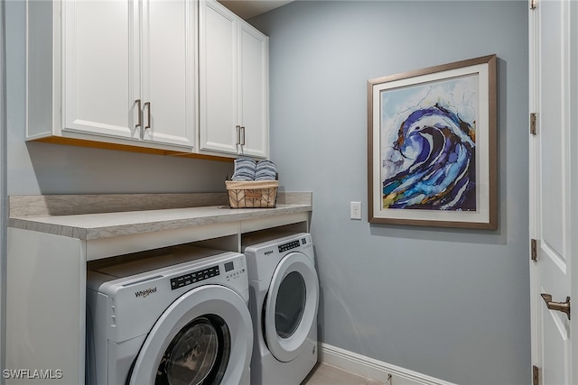 washroom featuring cabinets, independent washer and dryer, and light tile patterned floors