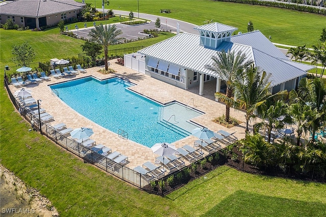 view of pool with a yard and a patio