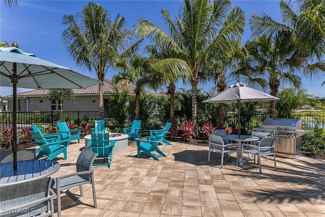 view of patio / terrace with grilling area and a fire pit