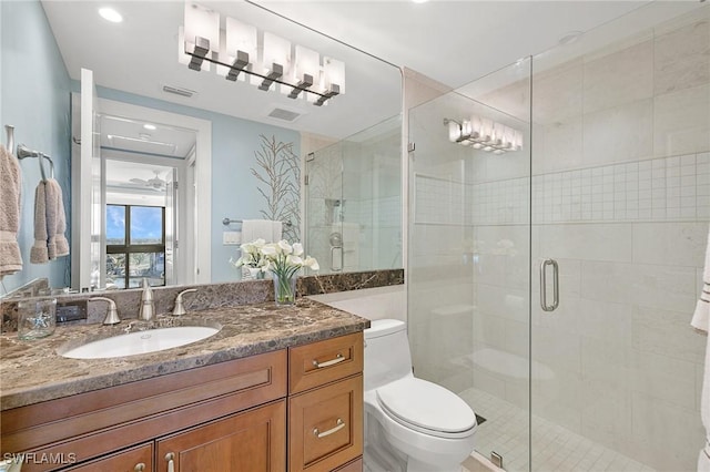 bathroom with vanity, an enclosed shower, and toilet