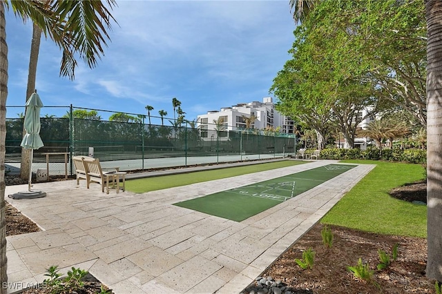 view of property's community featuring tennis court