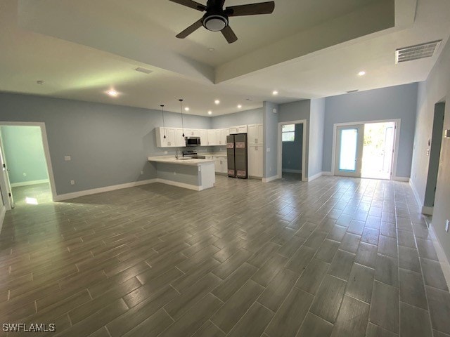 unfurnished living room with french doors, dark wood-type flooring, and ceiling fan