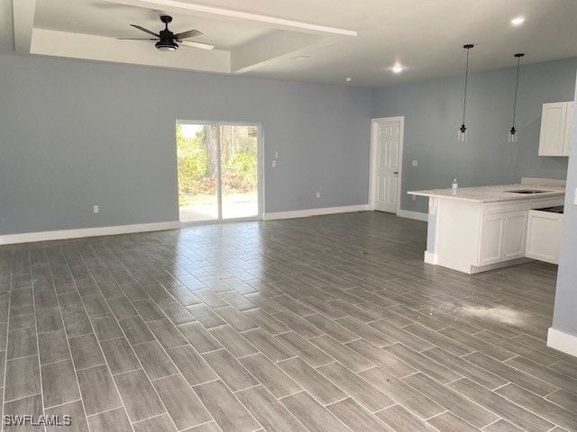 unfurnished living room with ceiling fan and light hardwood / wood-style floors