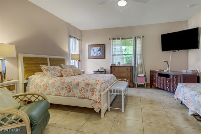 bedroom with ceiling fan and light tile patterned flooring