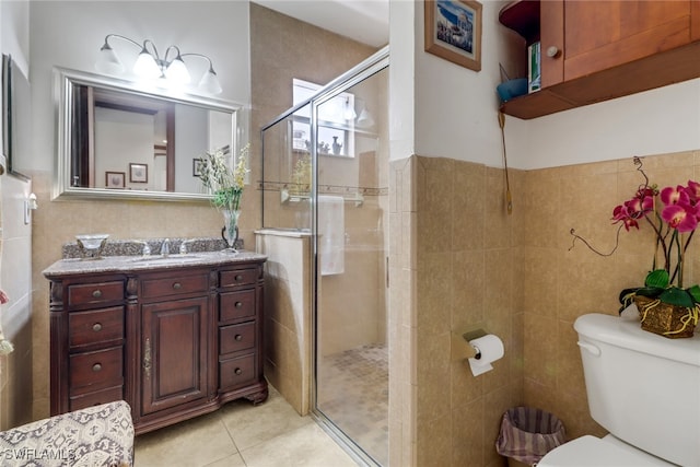 bathroom featuring tile walls, tile patterned floors, walk in shower, vanity, and toilet