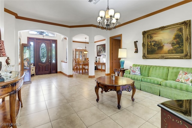 foyer entrance featuring light tile patterned floors, crown molding, and an inviting chandelier