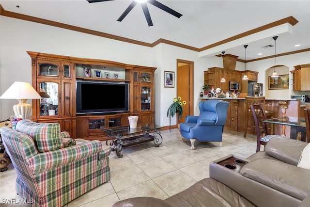 tiled living room featuring ceiling fan and ornamental molding