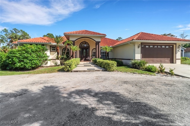 mediterranean / spanish-style house featuring a garage