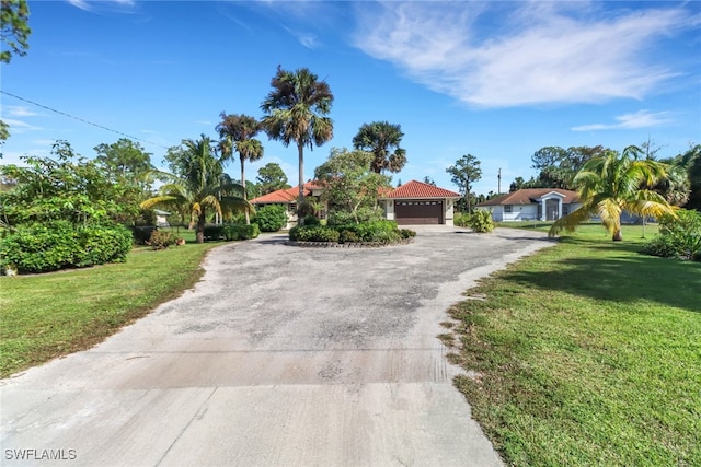 view of front of home featuring a garage and a front yard