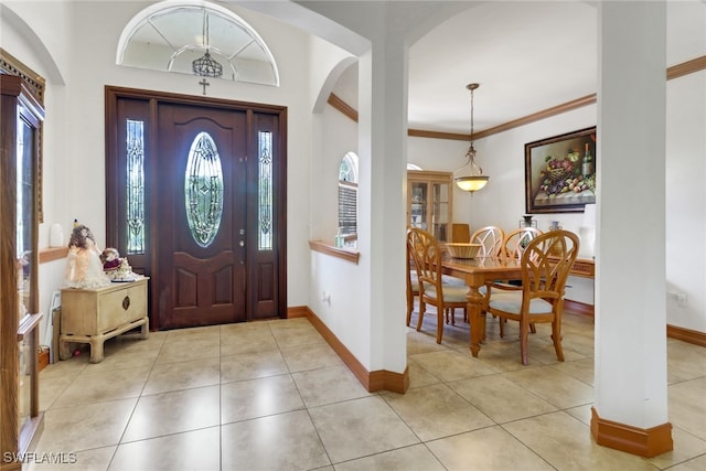 tiled foyer entrance with ornamental molding