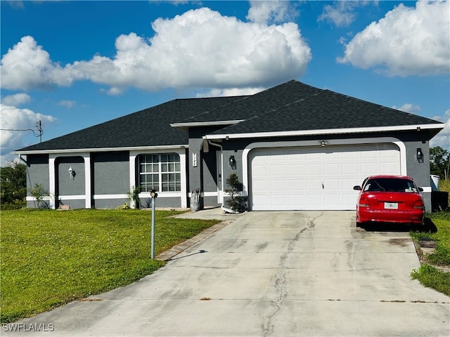 ranch-style house featuring a garage and a front lawn