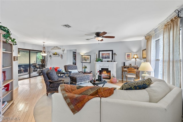 living room with ceiling fan and light hardwood / wood-style floors