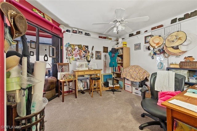 carpeted office space featuring ceiling fan