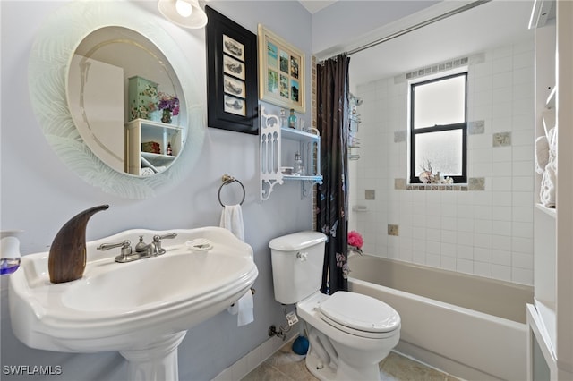 full bathroom featuring tile patterned flooring, toilet, sink, and shower / tub combo with curtain