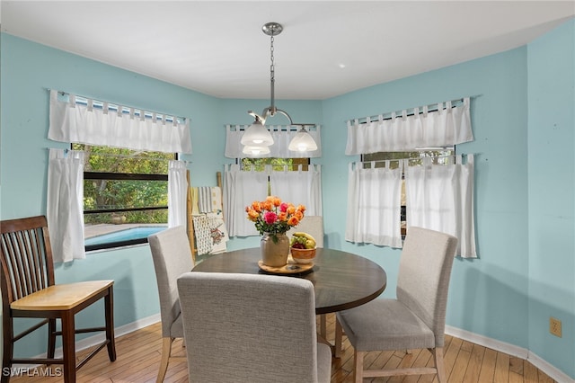 dining space with a notable chandelier and wood-type flooring