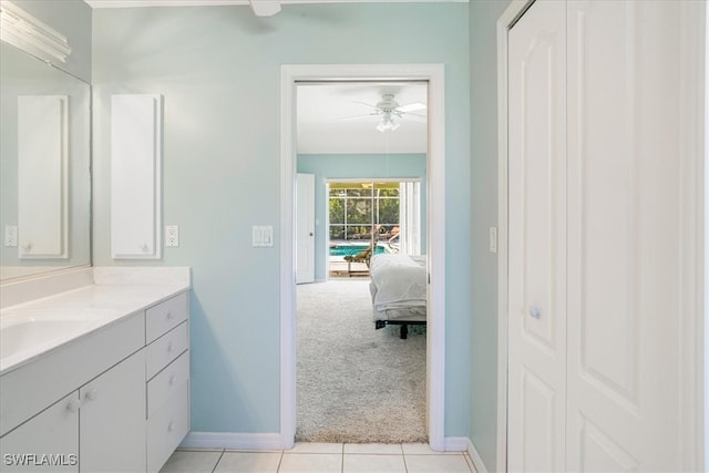 bathroom with tile patterned flooring, ceiling fan, and vanity