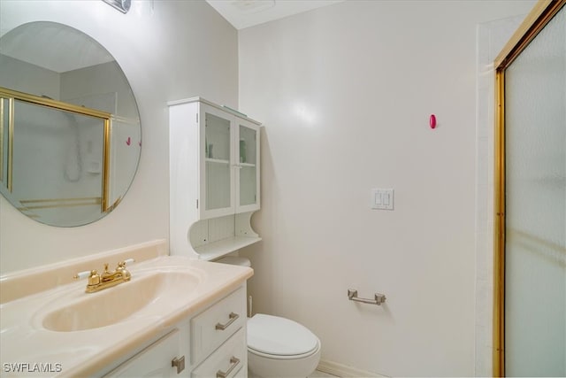 bathroom with vanity, toilet, and an enclosed shower