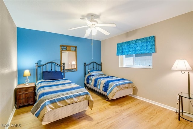 bedroom with ceiling fan and light wood-type flooring