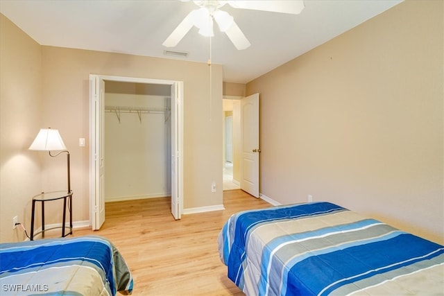 bedroom with wood-type flooring, a closet, and ceiling fan