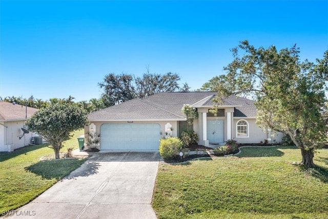 view of front of home featuring central AC unit, a garage, and a front lawn