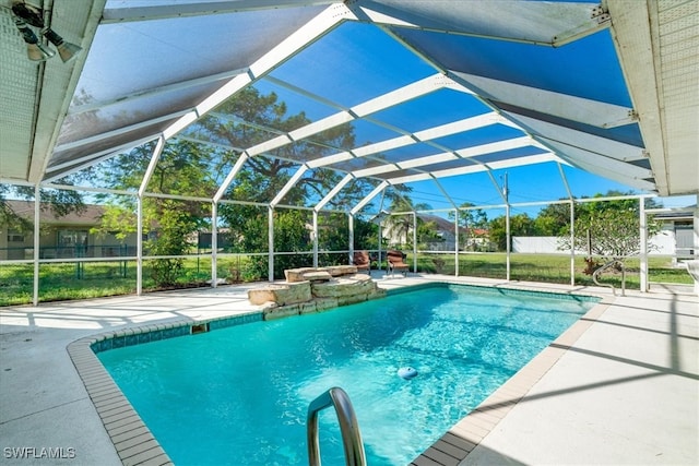 view of pool featuring glass enclosure and a patio area