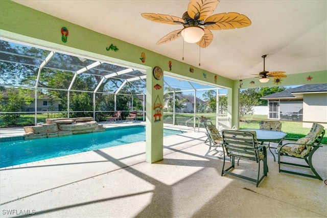 view of pool with glass enclosure and a patio area