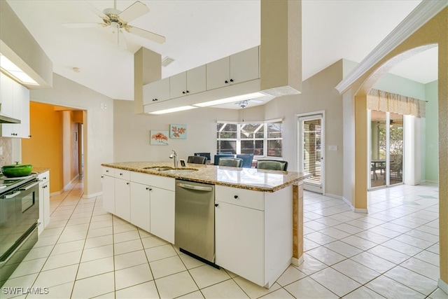 kitchen with appliances with stainless steel finishes, light stone counters, sink, white cabinetry, and light tile patterned flooring