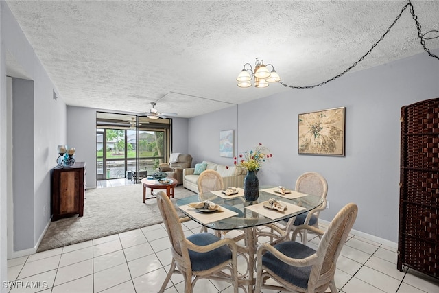 dining area with light carpet, ceiling fan with notable chandelier, and a textured ceiling