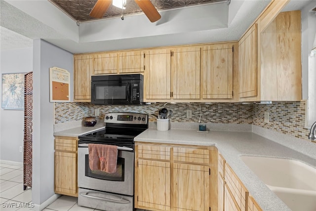 kitchen with light brown cabinetry, electric range, and sink