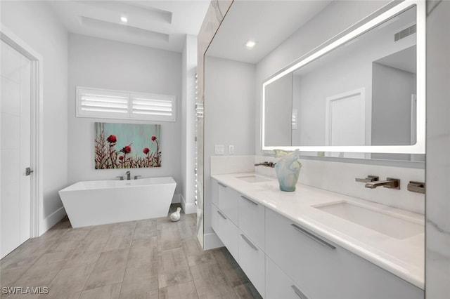 bathroom with vanity and a tub