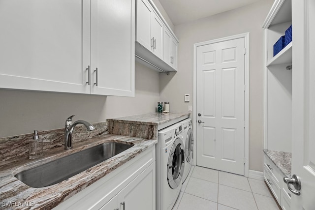 laundry room with washing machine and dryer, cabinets, sink, and light tile patterned floors