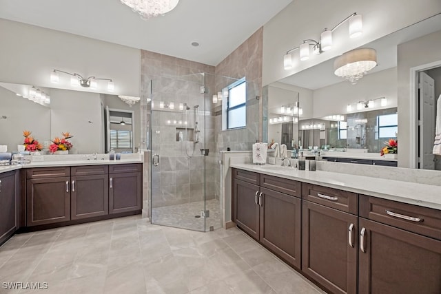 bathroom featuring vanity and a shower with door