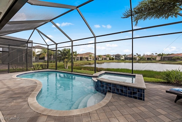 view of pool featuring a patio, glass enclosure, an in ground hot tub, and a water view