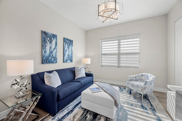 living room with a notable chandelier and hardwood / wood-style flooring