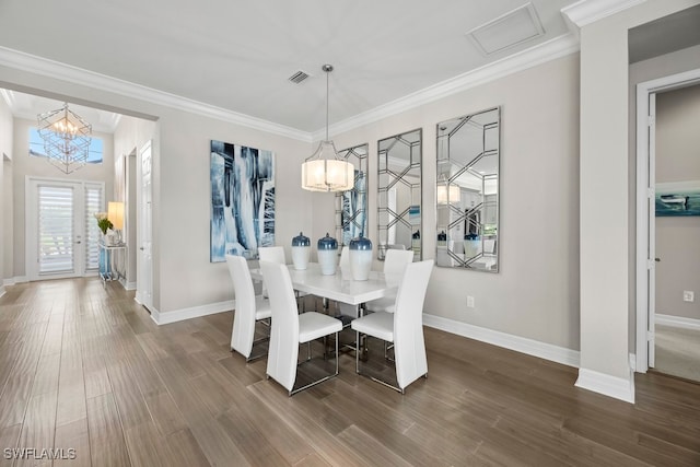 dining area with a chandelier, crown molding, and dark hardwood / wood-style flooring