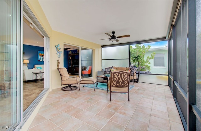 sunroom / solarium featuring ceiling fan