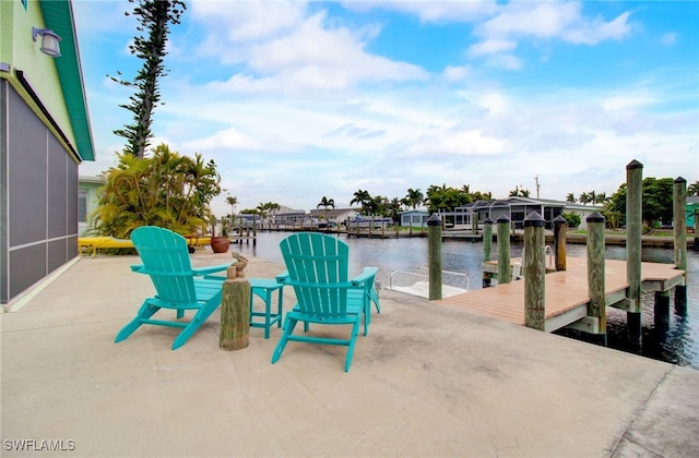 view of patio with a dock and a water view