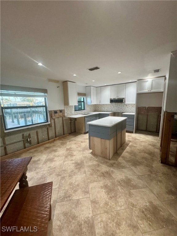 kitchen with white cabinetry and a center island