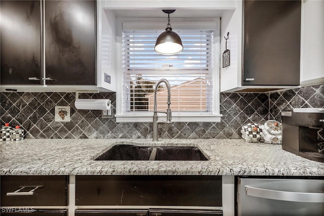 kitchen with decorative backsplash, dark brown cabinetry, hanging light fixtures, and sink