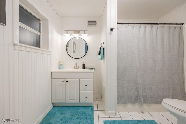 bathroom featuring vanity, tile patterned flooring, toilet, and crown molding