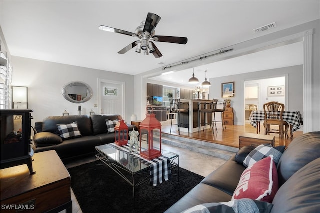 living room featuring ceiling fan and light tile patterned floors