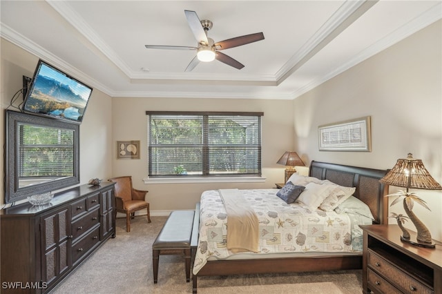 bedroom with a tray ceiling, multiple windows, and ceiling fan