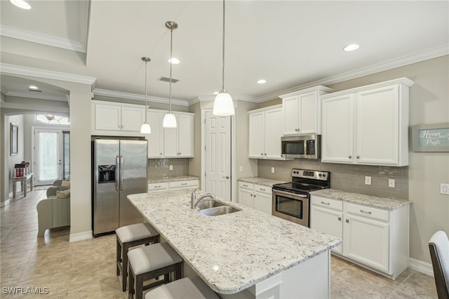 kitchen featuring white cabinetry, stainless steel appliances, sink, and decorative light fixtures