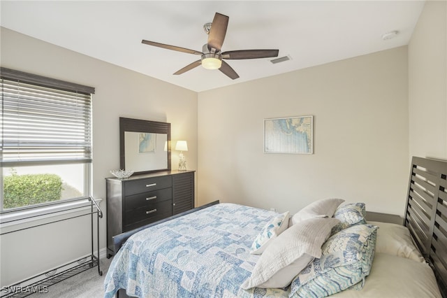 bedroom featuring ceiling fan and carpet