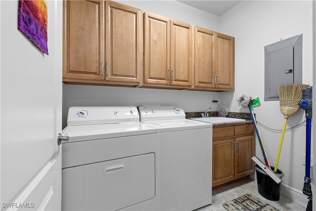 laundry area featuring washer and clothes dryer, cabinets, sink, and electric panel