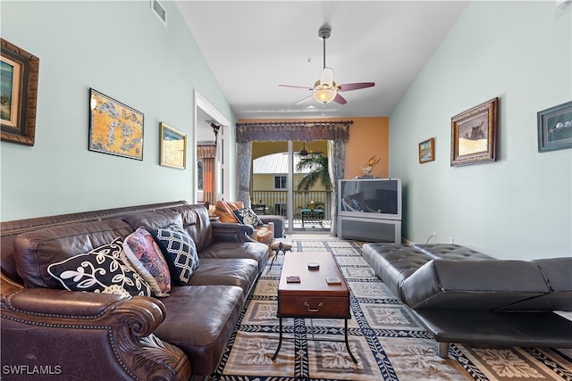 living room featuring ceiling fan and lofted ceiling