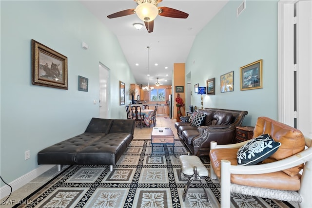 tiled living room with ceiling fan and high vaulted ceiling