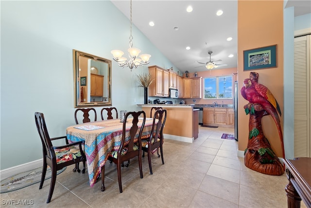 dining space featuring light tile patterned floors, ceiling fan with notable chandelier, and high vaulted ceiling