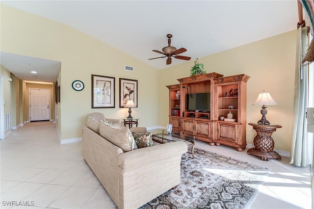 living room featuring ceiling fan, light tile patterned floors, and lofted ceiling