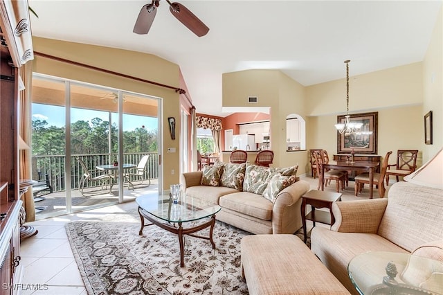 tiled living room with vaulted ceiling and ceiling fan with notable chandelier